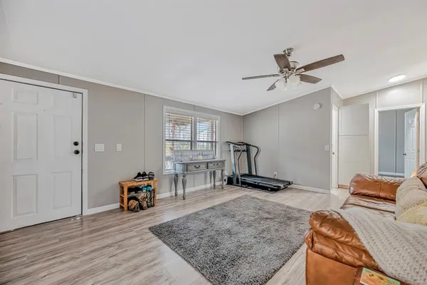 a living room with furniture and a wooden floor