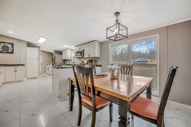 a dining room with furniture and window