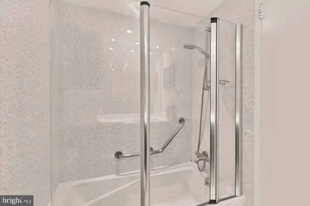 a bathroom with a glass shower door