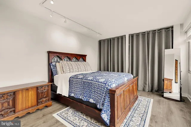 a bedroom with a bed and wooden floor