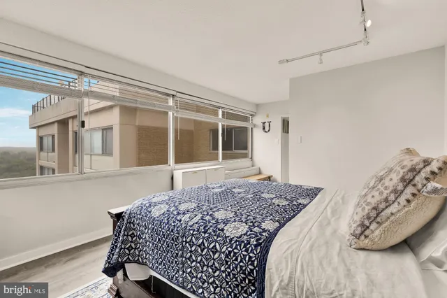 a bed sitting in a bedroom next to a window