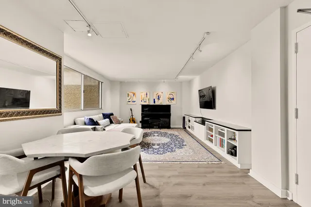a view of a dining room with furniture and a flat screen tv