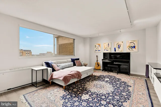 a bedroom with furniture and a rug