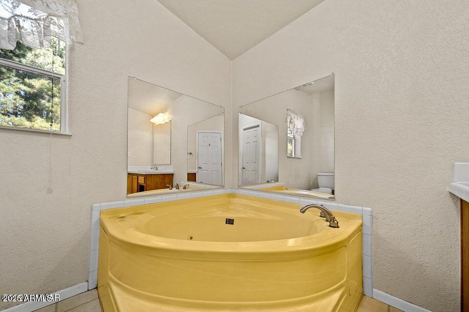 2421 West Thornton Road Show Low, AZ 85901 - Photo 23 of 48 a bathroom with a tub and sink