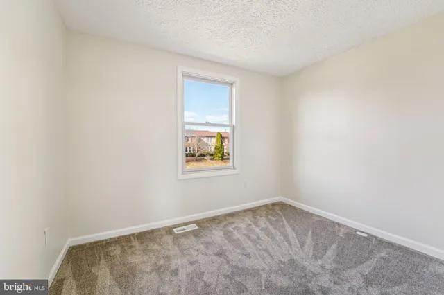 a view of an empty room and a window