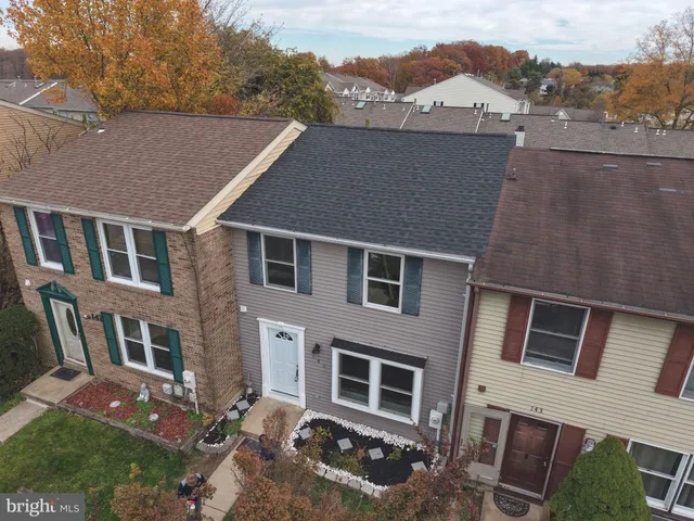 an aerial view of residential houses with outdoor space