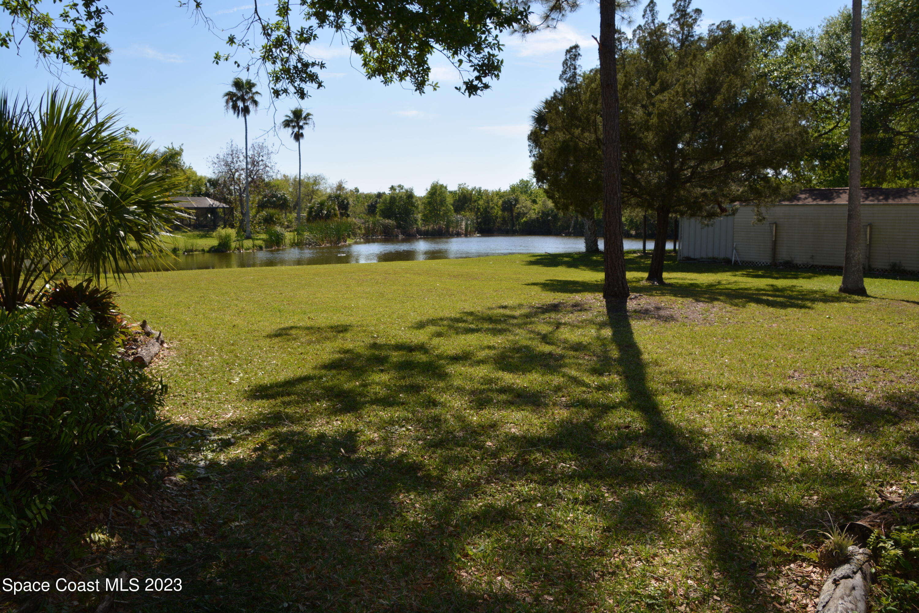 1045 Pine Island Road Merritt Island, FL 32953 - Photo 25 of 42 a view of a swimming pool with an outdoor space and seating area