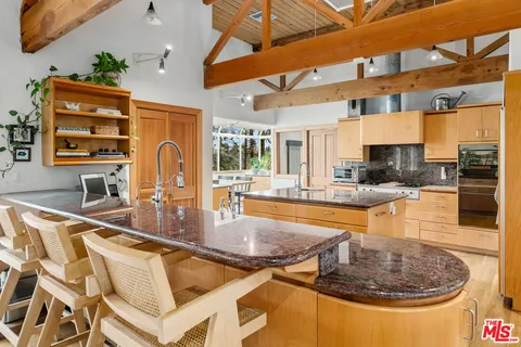 a kitchen with stainless steel appliances granite countertop a sink and a counter space