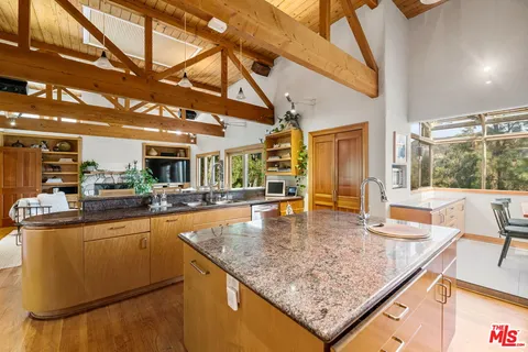 a view of a living room and kitchen