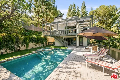 a front view of a house with a yard table and chairs