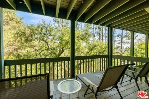 a view of a chair and table in the balcony