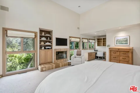 a bathroom with a granite countertop tub sink and mirror
