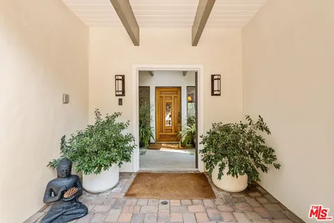a view of a porch with dining table and chairs