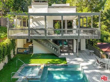 a view of a backyard with sitting area