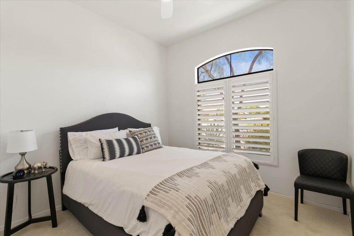 4211 East Kirkland Road Phoenix, AZ 85050 - Photo 12 of 23 a bedroom with a bed and a chair