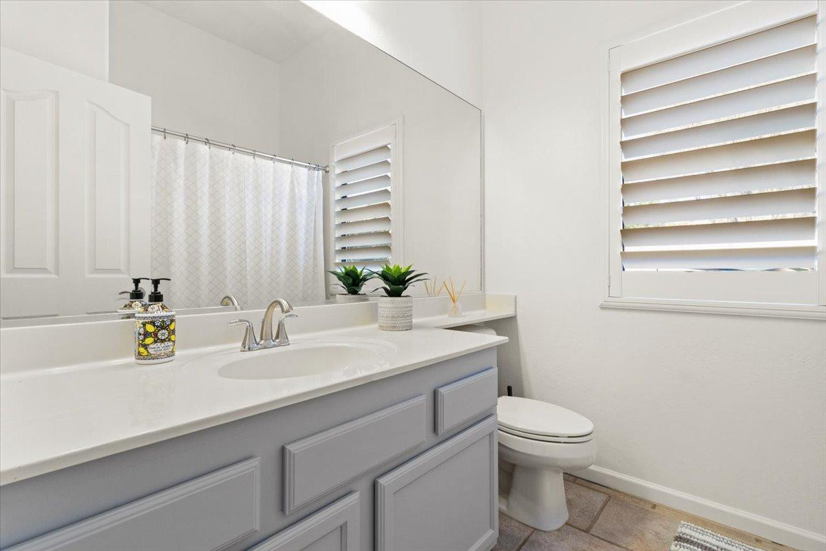 4211 East Kirkland Road Phoenix, AZ 85050 - Photo 13 of 23 a bathroom with a granite countertop sink and a toilet