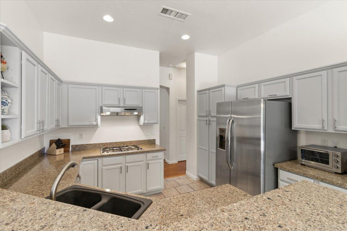 4211 East Kirkland Road Phoenix, AZ 85050 - Photo 6 of 23 a kitchen with a refrigerator sink and cabinets