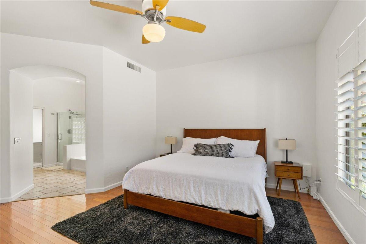 4211 East Kirkland Road Phoenix, AZ 85050 - Photo 8 of 23 a bedroom with a bed dresser and wooden floor