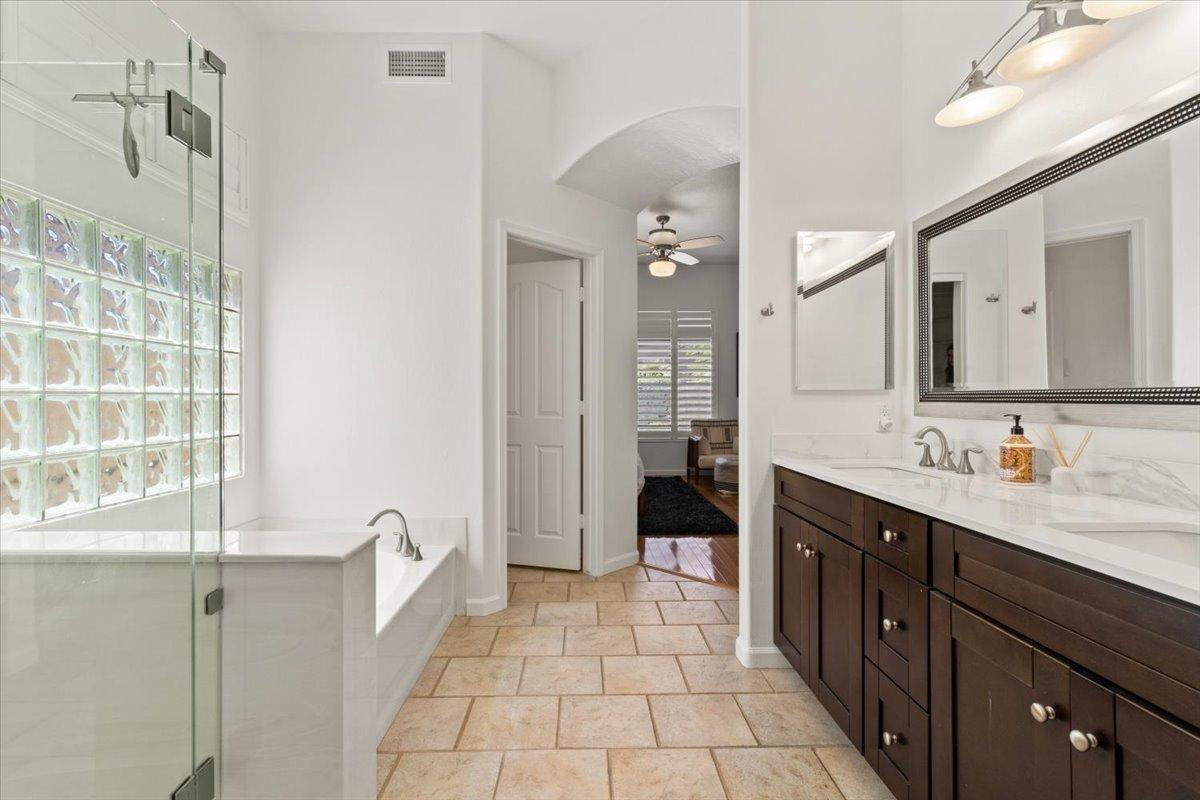 4211 East Kirkland Road Phoenix, AZ 85050 - Photo 9 of 23 a spacious bathroom with a double vanity sink a mirror and a shower