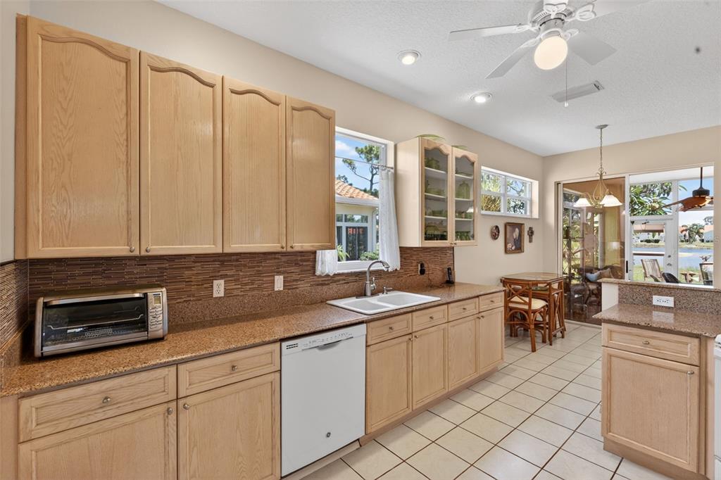 4266 Summertree Road Venice, FL 34293 - Photo 13 of 64 a kitchen with a sink and cabinets