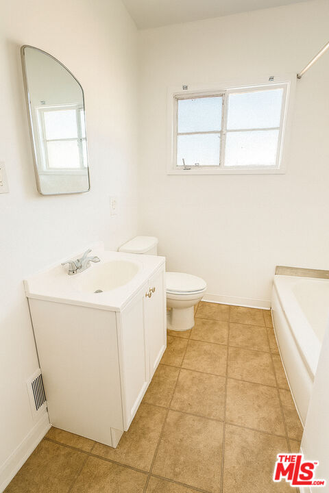 4064 South Muirfield Road, Unit C Los Angeles, CA 90008 - Photo 12 of 19 a bathroom with a sink a toilet and mirror