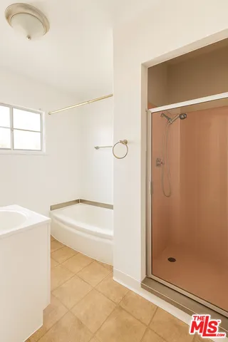 a bathroom with a bathtub and a shower