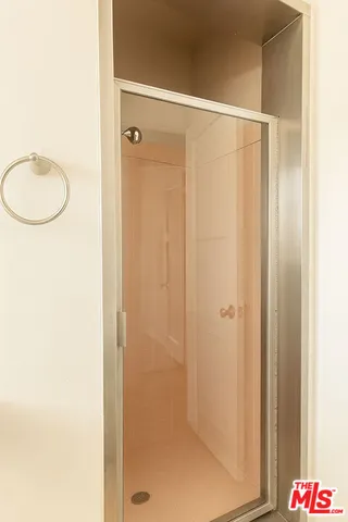a bathroom with a shower and a sink