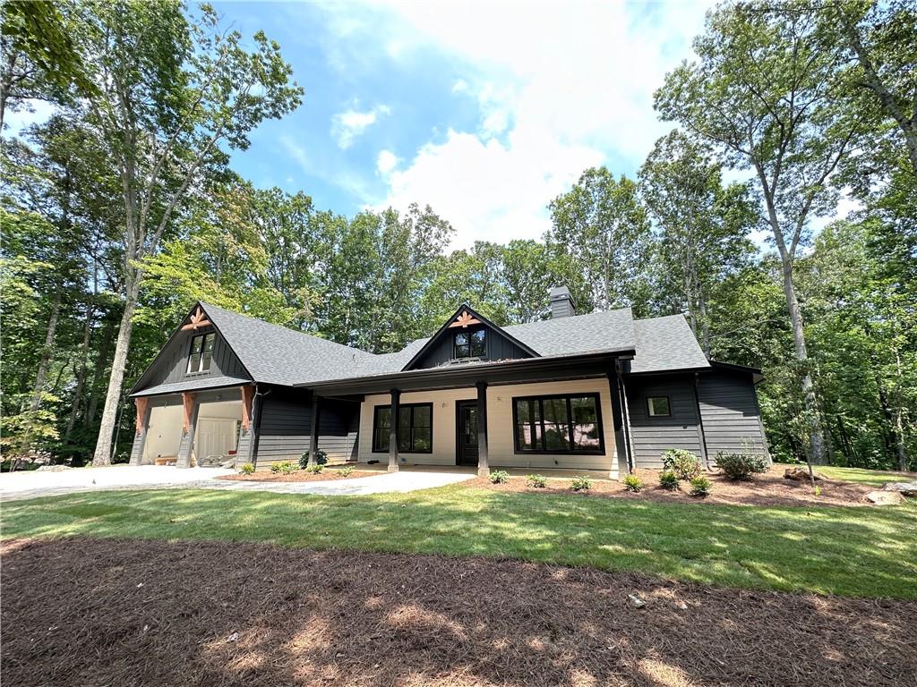 a front view of a house with a garden