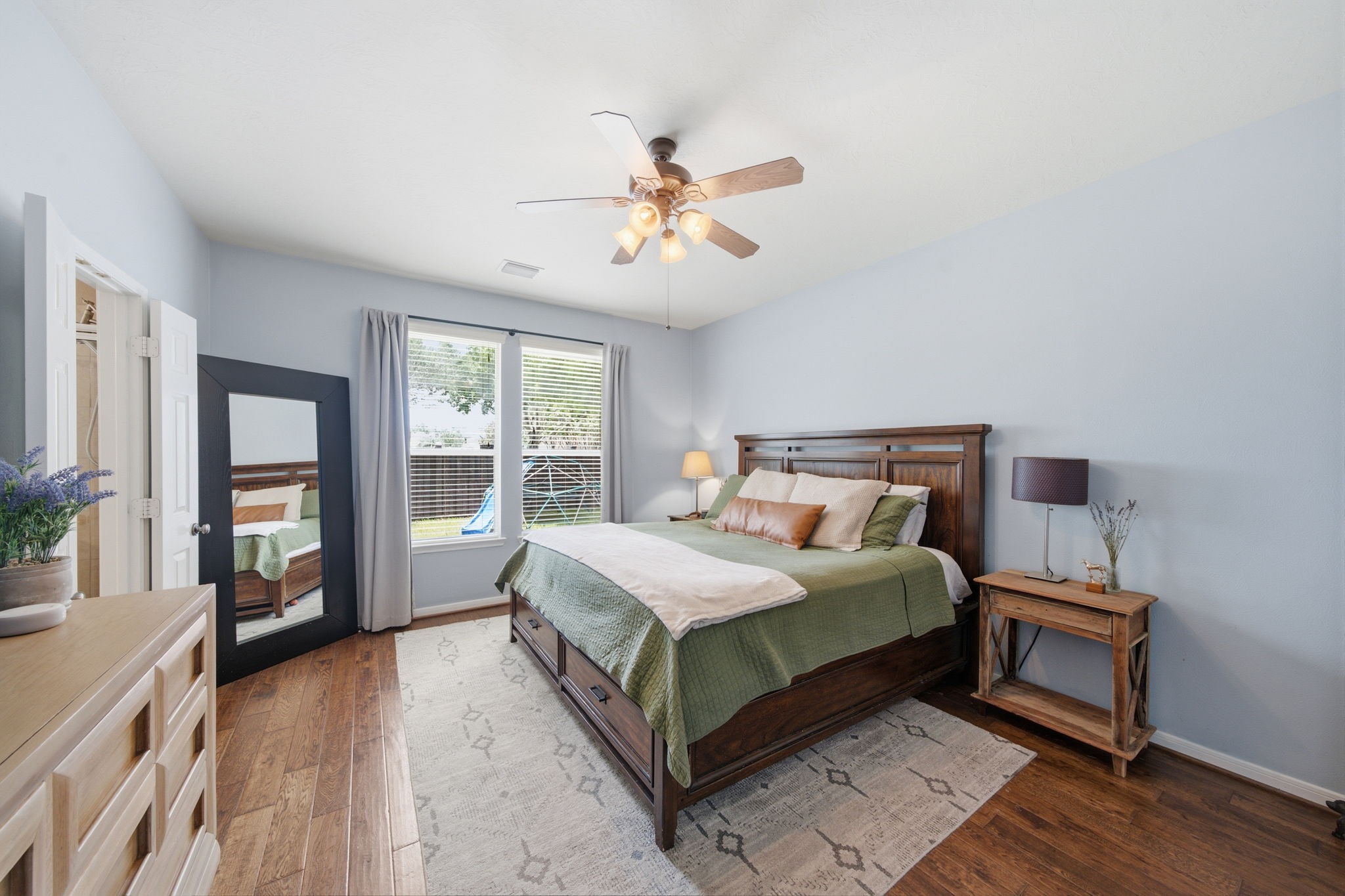 8911 Henrico Lane Rosenberg, TX 77469 - Photo 13 of 45 a bedroom with a large bed and a chandelier