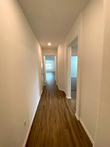a view of hallway with wooden floor