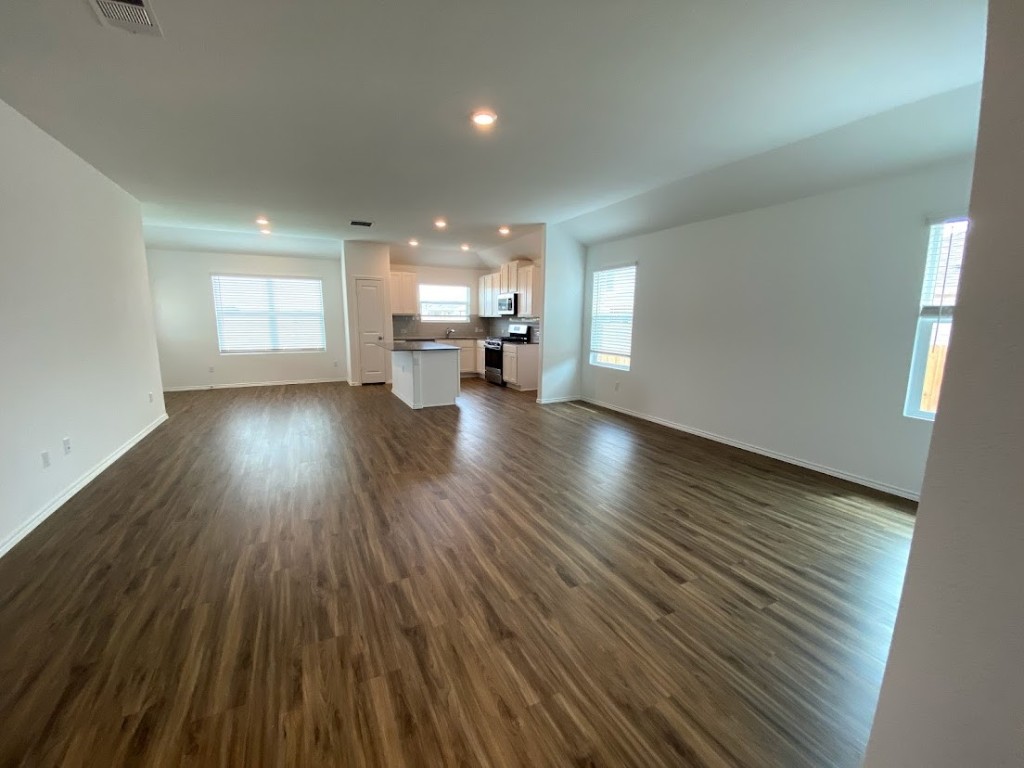 3106 Kenner Drive Pflugerville, TX 78660 - Photo 3 of 11 an empty room with wooden floor and windows