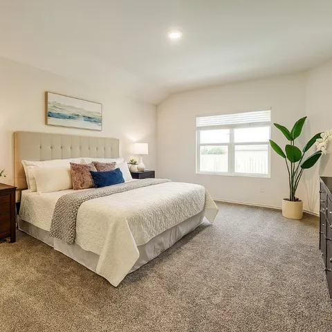 a bedroom with a bed and a window