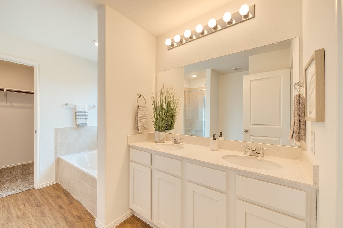 3106 Kenner Drive Pflugerville, TX 78660 - Photo 7 of 11 a bathroom with a sink double vanity and a mirror