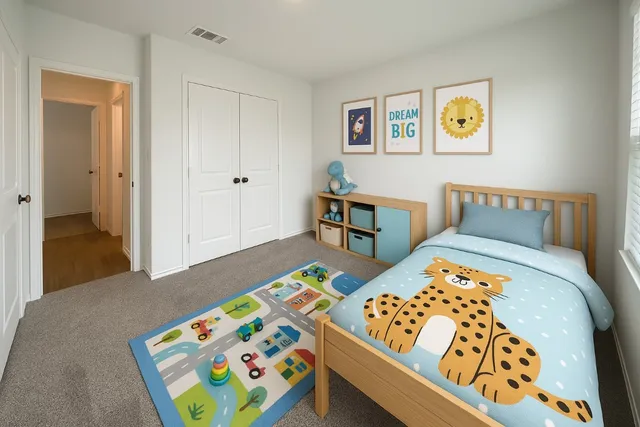 a bedroom with a bed and painting on the wall