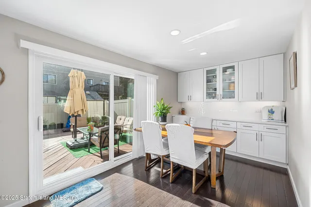 a view of a dining room with furniture and a potted plant