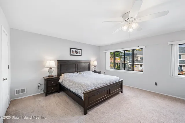 a spacious bedroom with a bed and window
