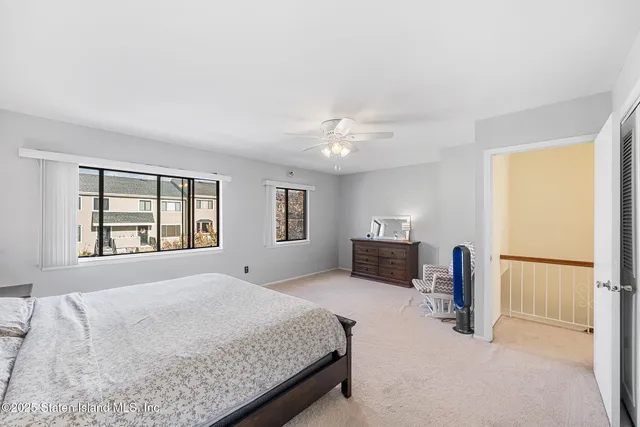 a spacious bedroom with a bed and a window