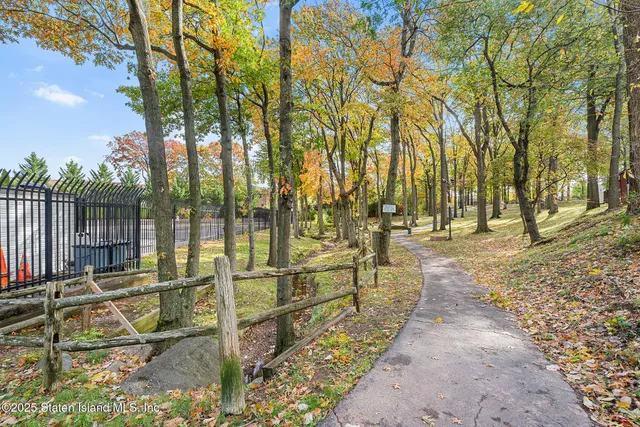 a view of a yard with wooden fence