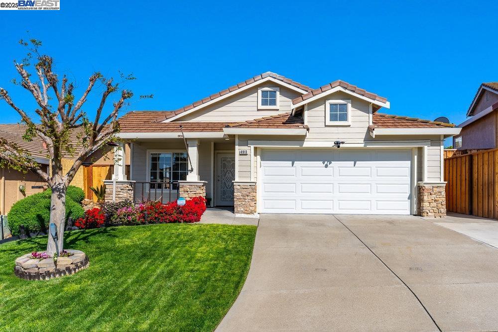a front view of a house with a yard and garage