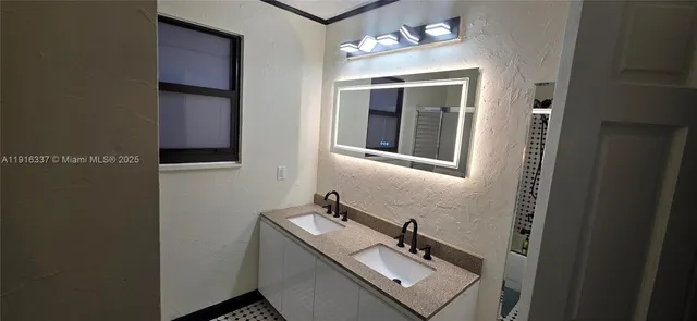 a bathroom with a sink and mirror