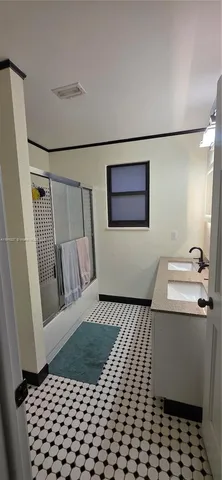 a bedroom with a bed and a mirror