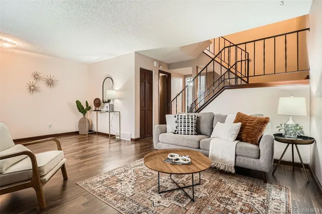 a living room with furniture and wooden floor
