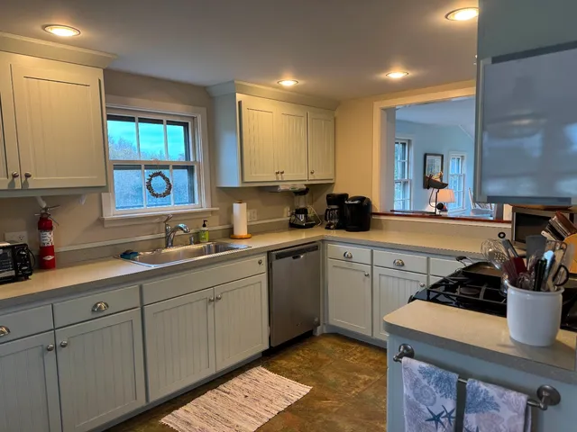 a kitchen with sink cabinets and window