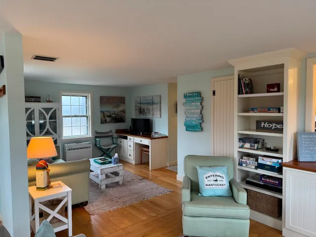 a living room with furniture and a lamp