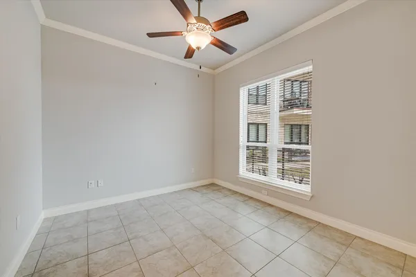 an empty room with closet and a chandelier fan