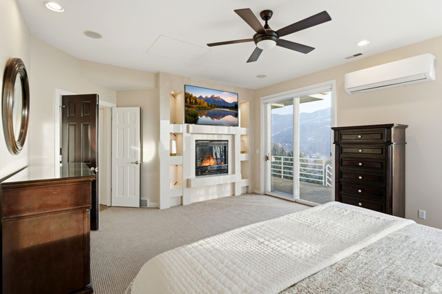 1878 East Ridge Point Drive Bountiful, UT 84010 - Photo 23 of 92 Bedroom with light colored carpet, access to exterior, a ceiling fan, a glass covered fireplace, and recessed lighting