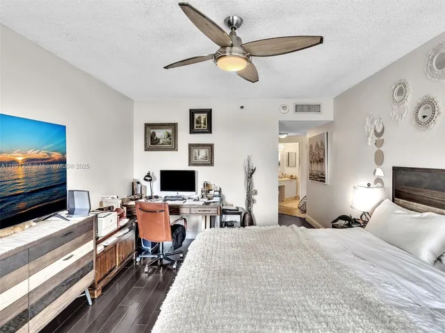 a bedroom with furniture and a flat screen tv