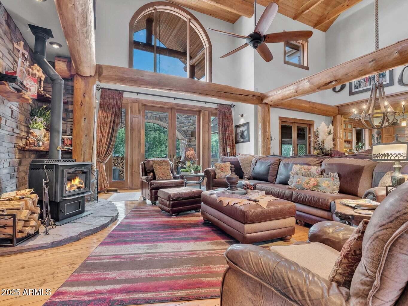 9361 Juniper Road Strawberry, AZ 85544 - Photo 15 of 104 a living room with furniture a fireplace and a chandelier