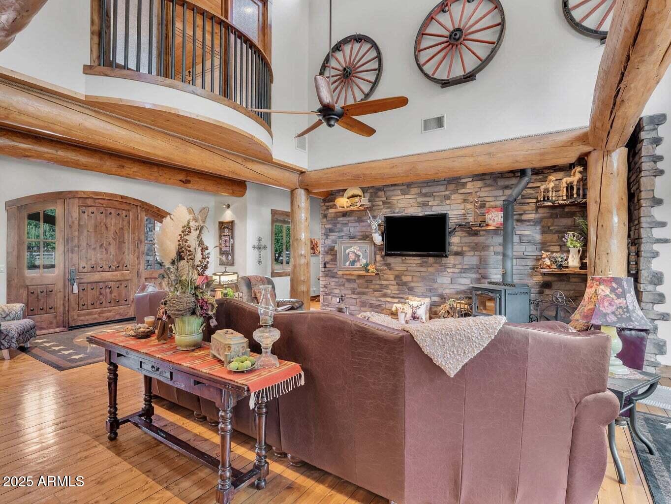 9361 Juniper Road Strawberry, AZ 85544 - Photo 16 of 104 a living room with furniture a flat screen tv and a wall clock