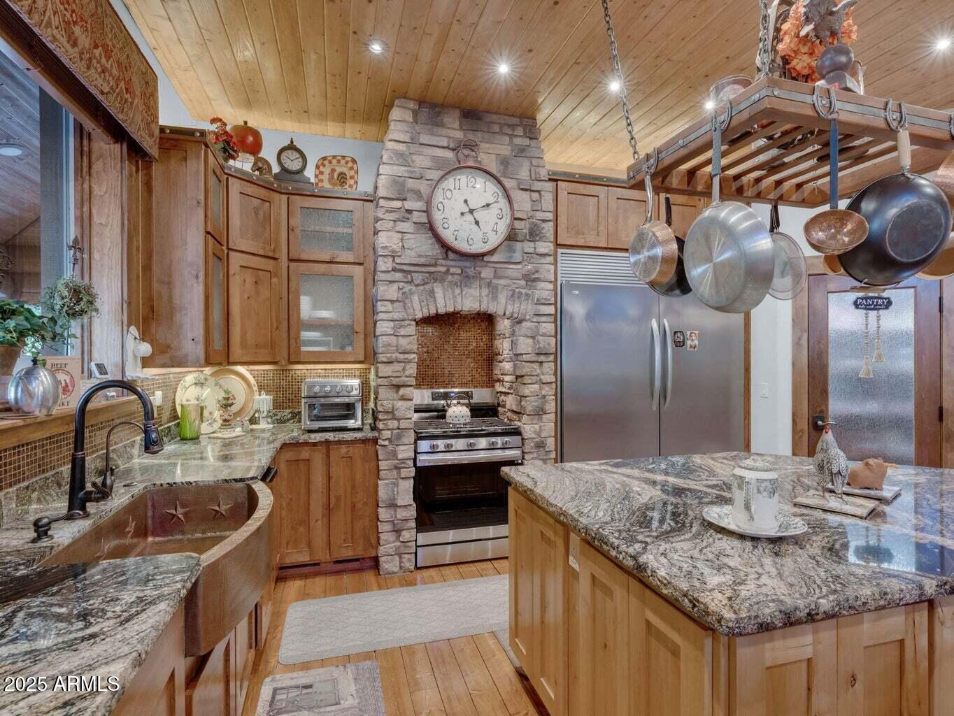9361 Juniper Road Strawberry, AZ 85544 - Photo 23 of 104 a kitchen with granite countertop a sink a stove top oven and refrigerator